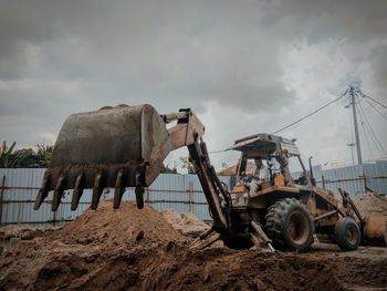 Man in bulldozer working at construction site