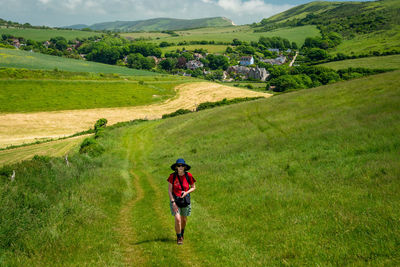 Rear view of man walking on field