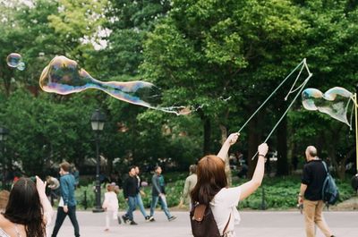 Woman making bubble at park