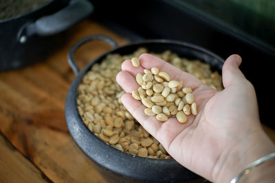 High angle view of person hand in container