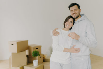 Portrait of smiling couple standing in new house