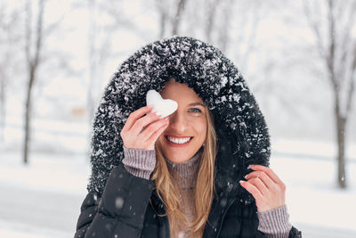 Portrait of smiling woman in snow