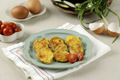 Pan fried korean zucchini pumpkin pancakes or hobak jeon, fried green pumpkin with flour and eggs.