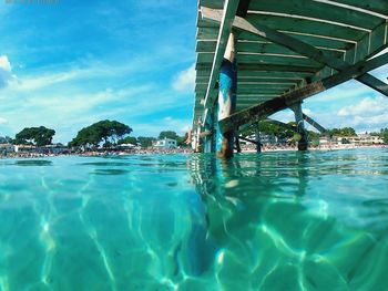 Swimming pool at beach against sky