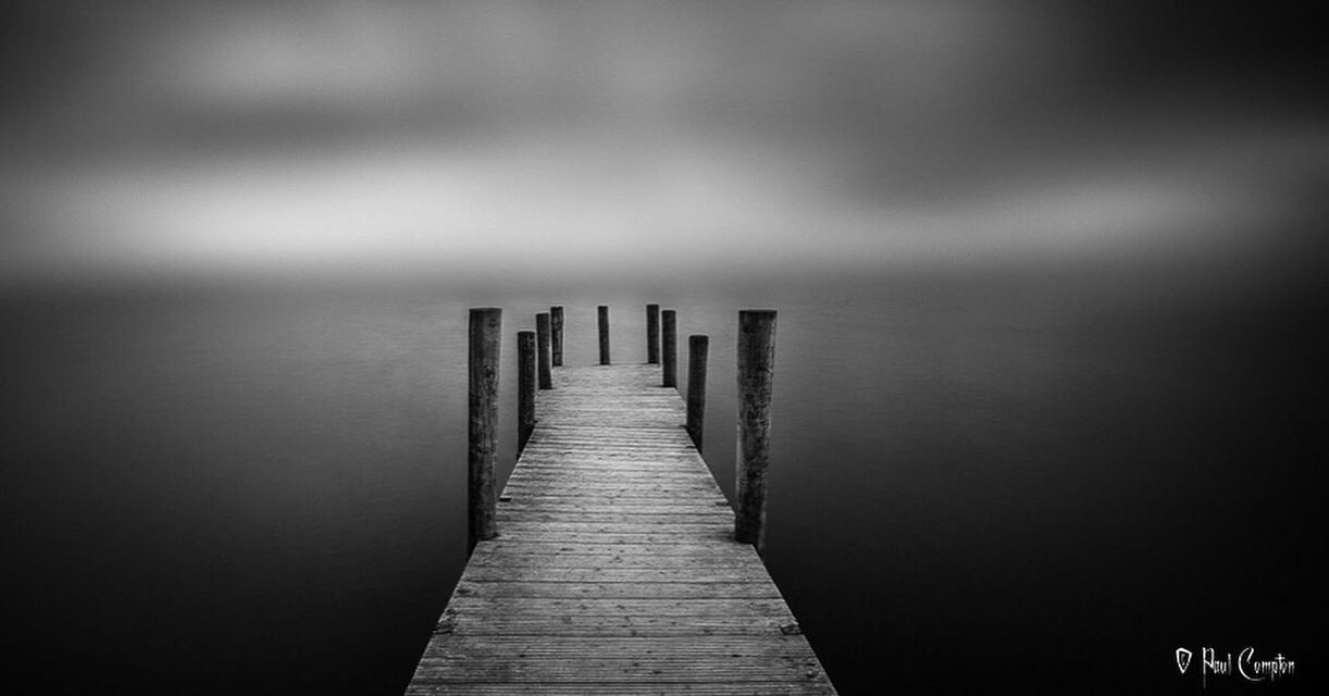 WOODEN PIER ON CALM LAKE