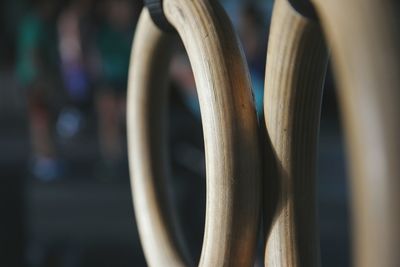 Close-up of wooden gymnastic rings in gym