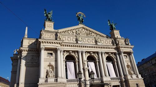 Low angle view of statue against blue sky