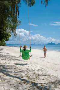 Full length of boy playing on beach