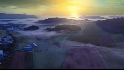 Aerial view of cityscape against sky during sunset