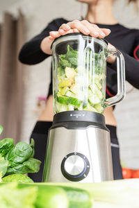 Midsection of woman preparing food in kitchen