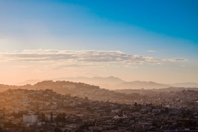 Aerial view of townscape against sky at sunset