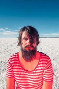 Mid adult man at beach against sky