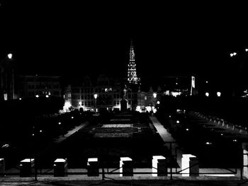 Illuminated city against sky at night