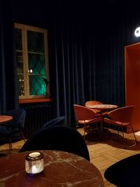 Empty chairs and table on floor at restaurant