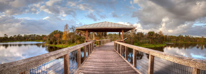 Sunset over gazebo on a wooden secluded, tranquil boardwalk along a marsh pond in freedom park 