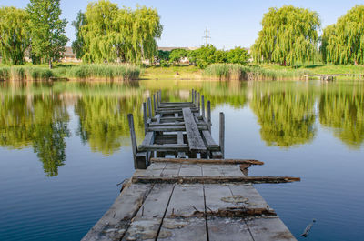 Wooden old ruined bridge pier on small lake. rest, fishing, rest on the water