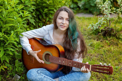 Young woman playing guitar