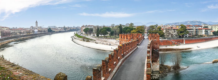 Extra wide angle view of the adige river, the panorama of verona and the castelvecchio bridge