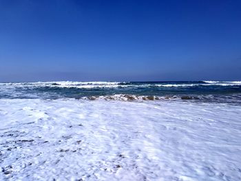 Scenic view of sea against clear blue sky