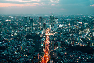 High angle view of city lit up at dusk