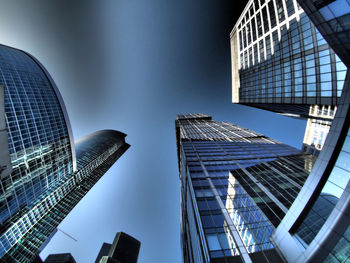 Low angle view of modern building against blue sky