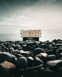 Pebbles on beach against sky