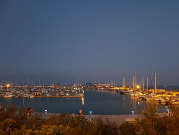 Sailboats in sea against clear sky at night