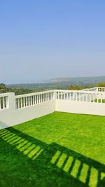 Built structure on grassland against clear sky