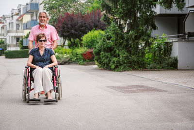 Full length of couple sitting on swing