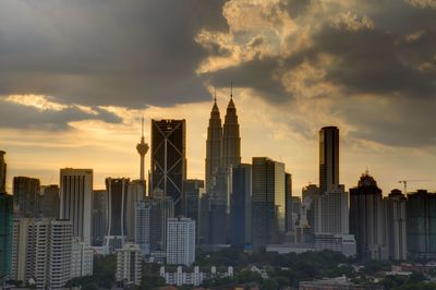 View of cityscape against cloudy sky