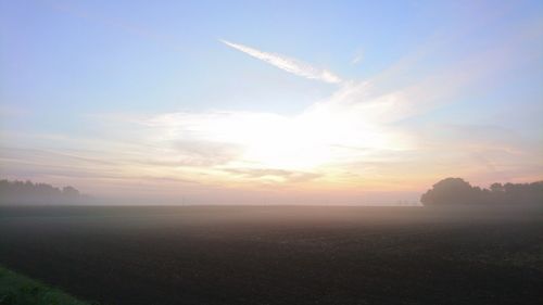 Scenic view of field against sky during sunset