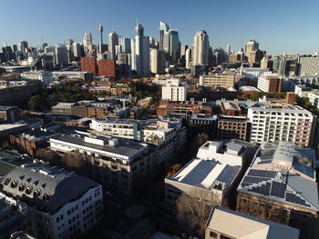 Aerial view of buildings in city against sky