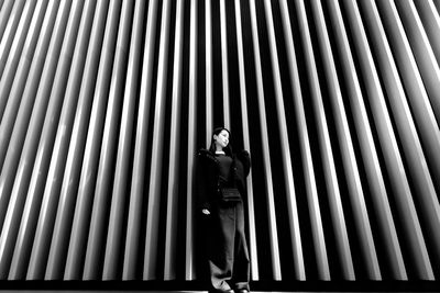 Portrait of woman standing on metallic structure