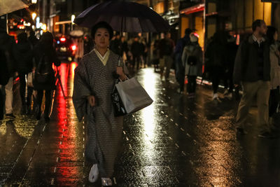 Group of people on wet street at night