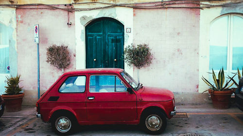 View of car on street against old building