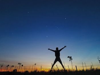 Silhouette man jumping against sky during sunset