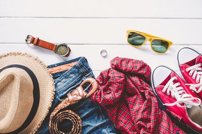 High angle view of clothing with various objects on table