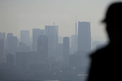 Silhouette buildings against sky in city