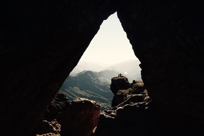 Scenic view of mountains against cloudy sky