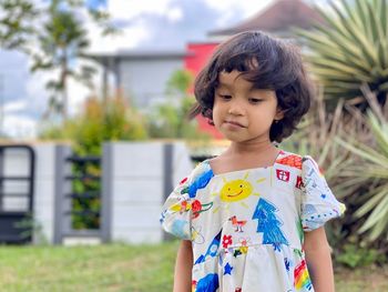 Portrait of cute girl standing outdoors