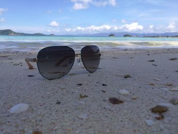 Close-up of beach against sky