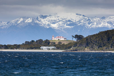 Scenic view of sea and mountains against sky