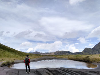 Full length of man standing on lake against sky