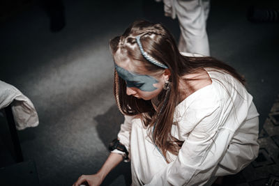 High angle view of woman sitting on floor