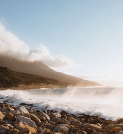 Scenic view of waterfall against sky