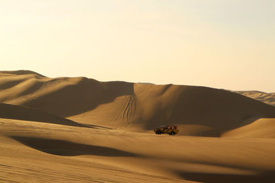 Scenic view of desert against clear sky