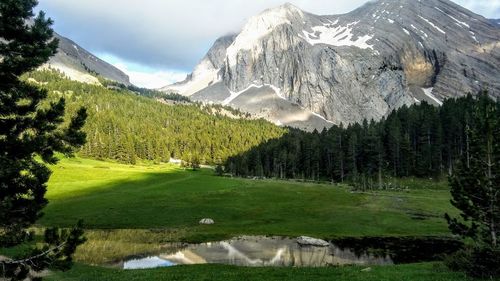 Scenic view of landscape and mountains against sky