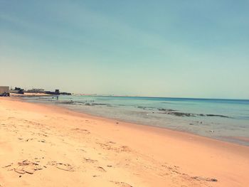Scenic view of beach against clear sky