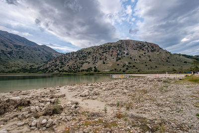 Scenic view of lake and mountains against sky