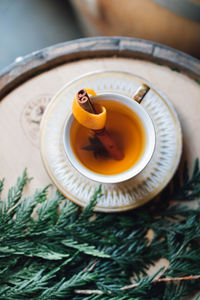 Festive holiday winter hot toddy in teacup on whiskey barrel